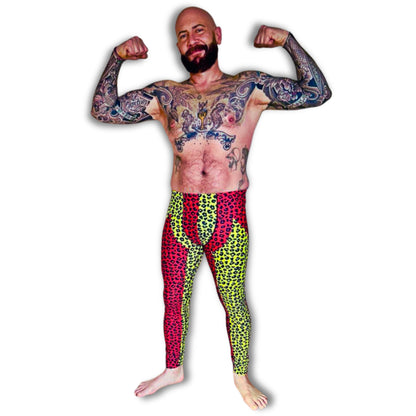 Man flexing muscles wearing a colorful split color red and yellow leopard print pro wrestling cosplay outfit on a white background