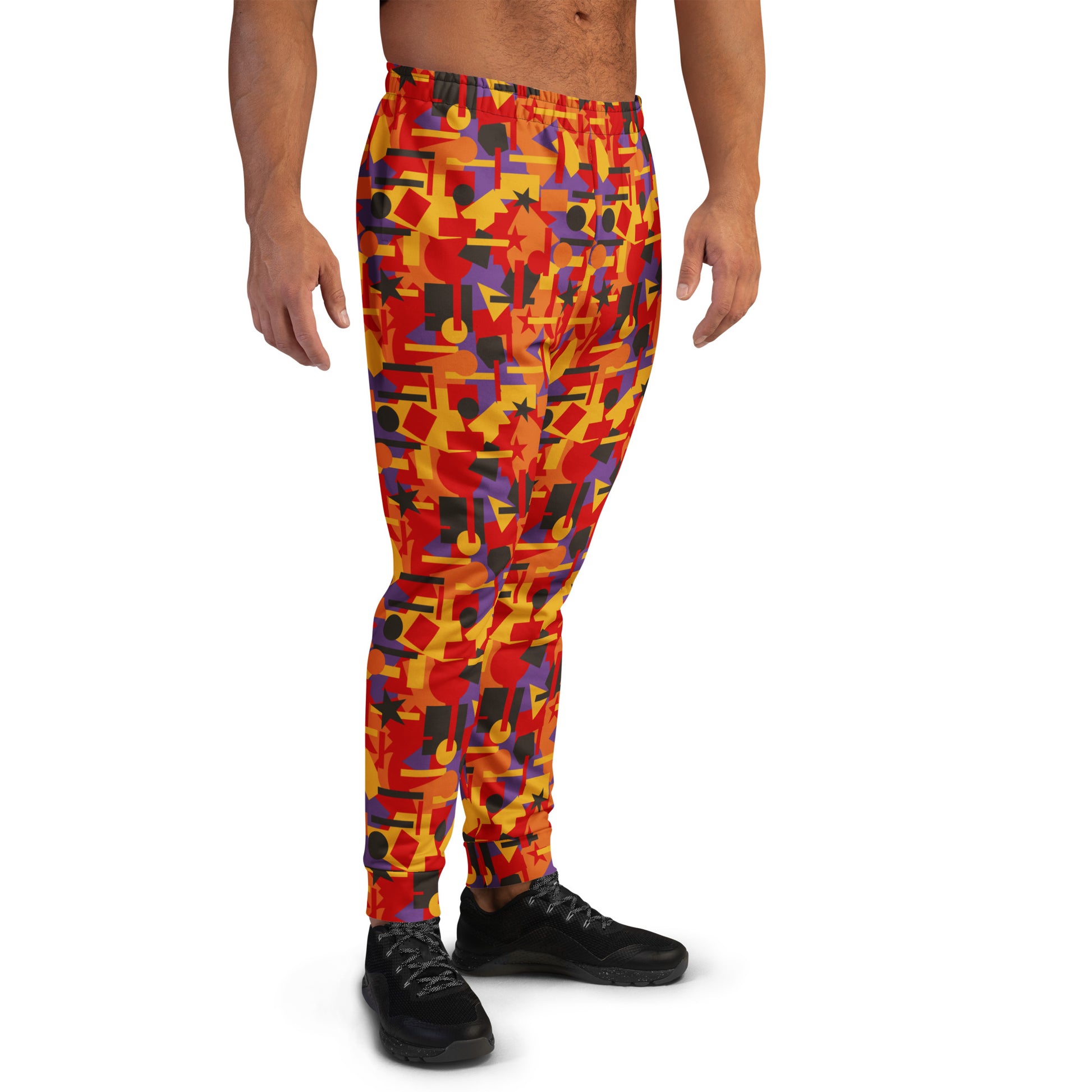 Multicolored geometric patterned pants worn by a person on a white background