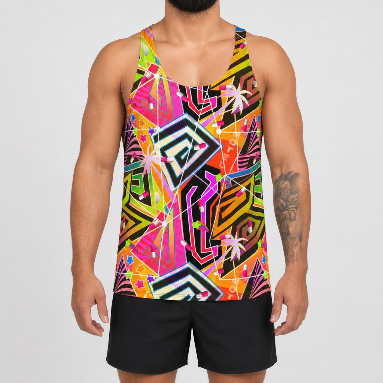 A man wearing a sleeveless athletic tank top with a vibrant, multicolored geometric abstract pattern in pink, yellow, green, orange, and black, paired with black athletic shorts, against a light gray background.