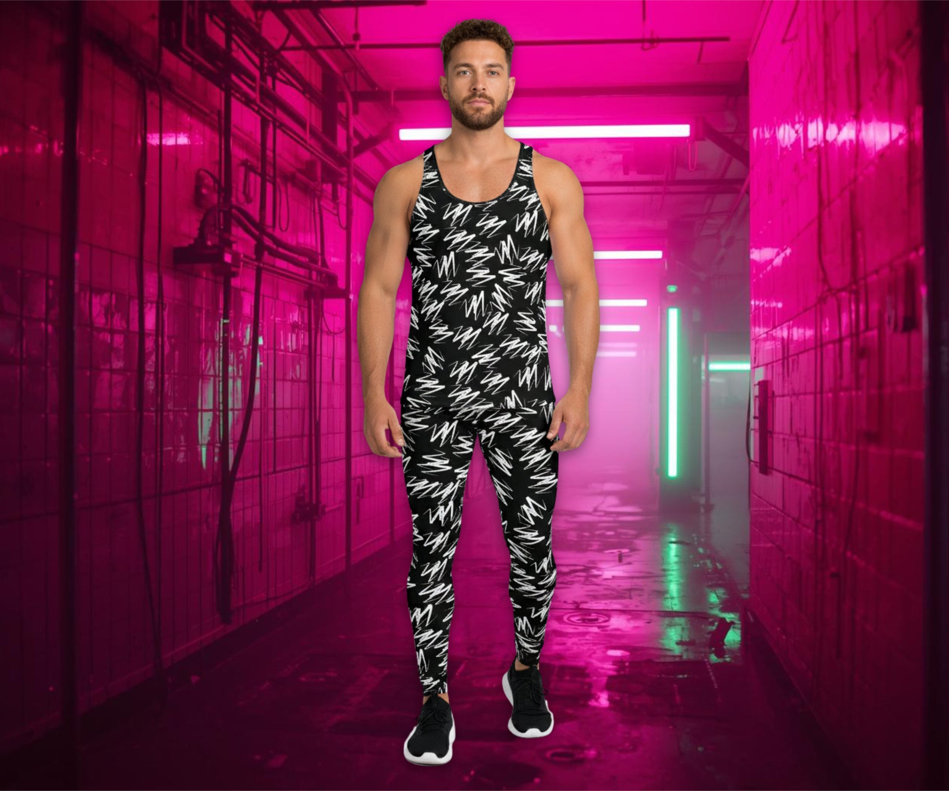 Man wearing a black and white  zigzag patterned outfit in a pink-lit hallway.