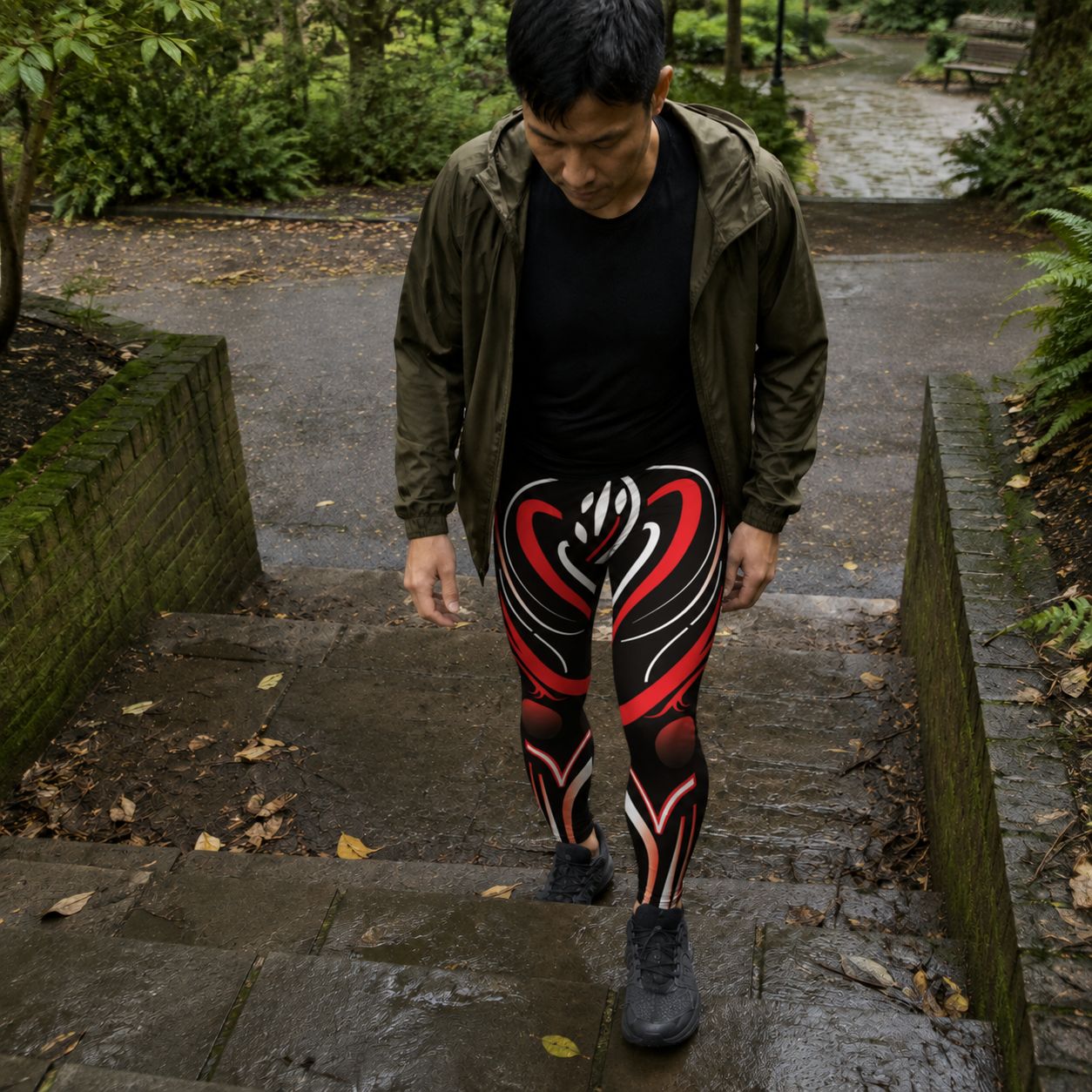 Man walking up some steps wearing the red and black Pulse Grid gym tights for men.