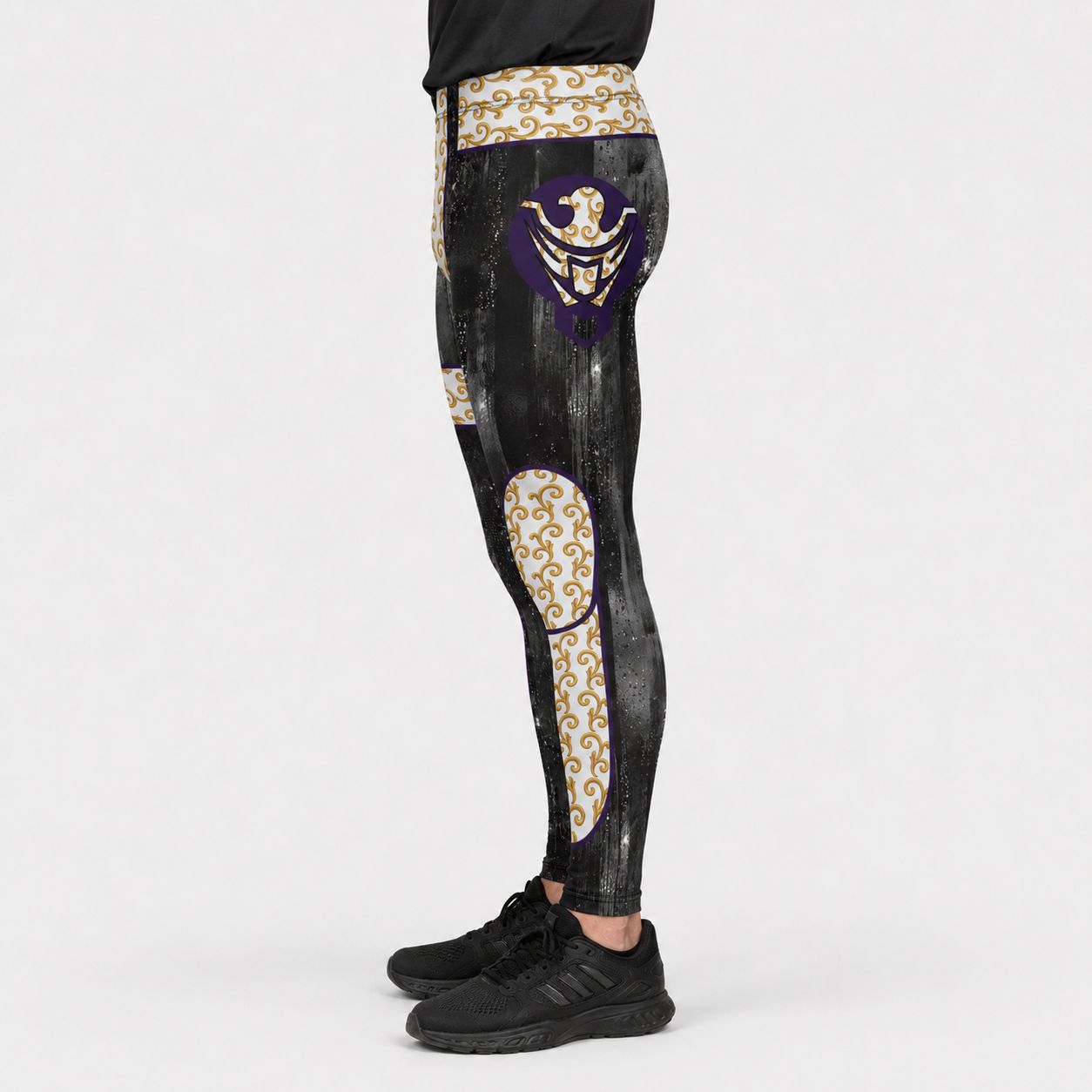 Black wrestling leggings with gold and purple designs and eagle motif on a white background