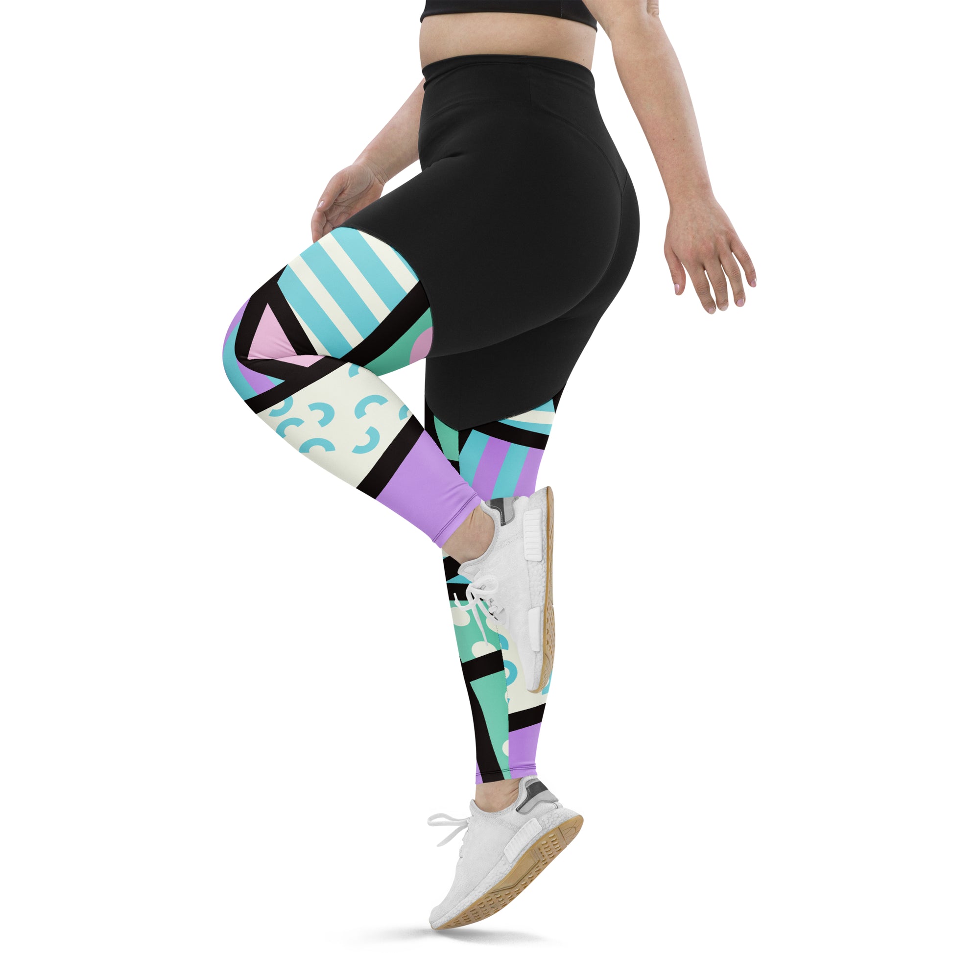 Sports leggings for women with black upper top and geometric pastel pink and blue patterned legs. Compression ankle length gym leggings with high elasticated waistband. Non-see through and squat proof leggings.