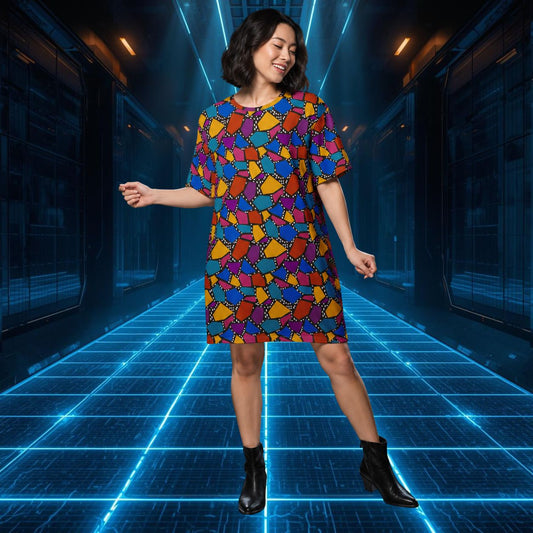 Woman in a colorful geometric t-shirt dress standing in a futuristic corridor with blue lighting.