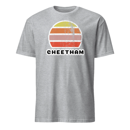 Distressed style abstract retro sunset graphic in yellow, orange, pink and scarlet stripes above the famous Manchester place name of Cheetham on this sport grey cotton t-shirt