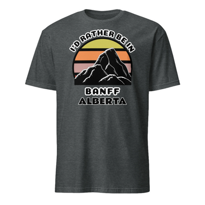 Banff Alberta vintage sunset mountain scene in silhouette, surrounded by the words I'd Rather Be In on top and Banff Alberta below on this dark heather cotton t-shirt