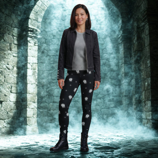 Woman wearing cute skull leggings standing in a gothic stone archway with a mystical atmosphere