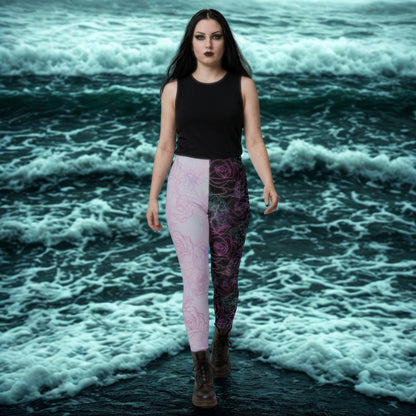 Woman wearing a black top and patterned pastel goth leggings standing in front of gothic ocean waves