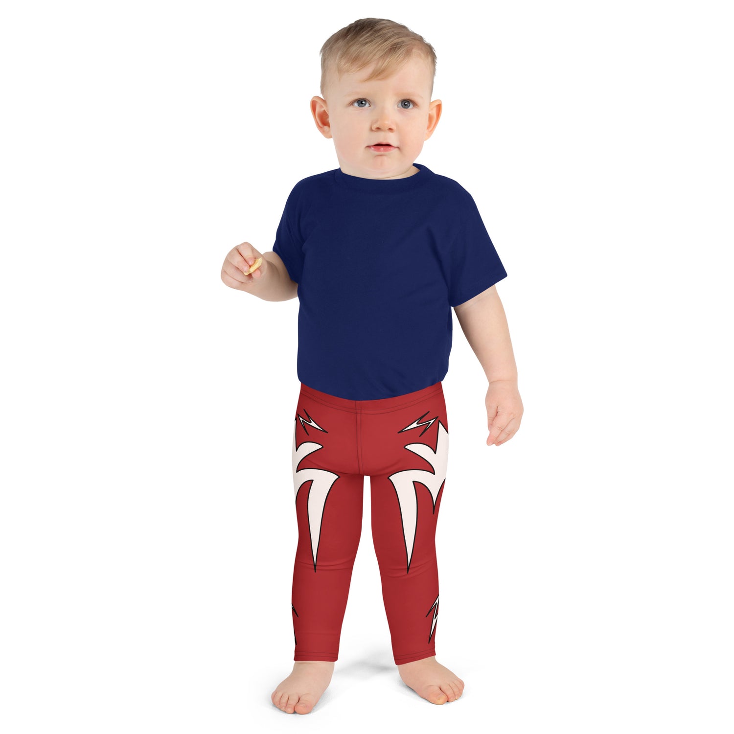 Child wearing bright red cosplay leggings with bold white lightning bolt graphics, inspired by superhero and wrestling styles.