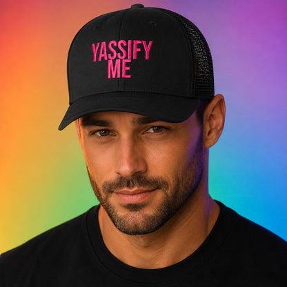 Man wearing a black truckers hat with the inscription, Yassify Me.