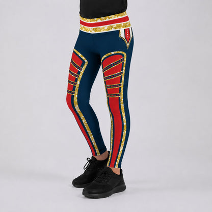 A person wearing navy blue leggings with bold red and gold military-style stripe patterns, paired with black sneakers, shown against a light gray studio background.