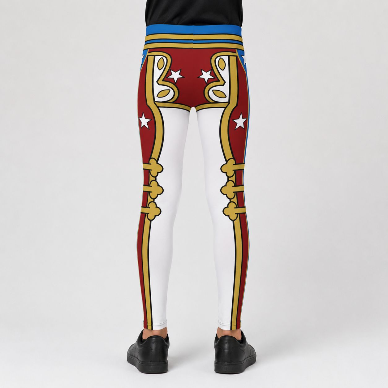 A boy shown from the back wearing cosplay wrestling pants with a red, white, gold, and blue retro military-style boot design, paired with black shoes, against a light gray studio background.