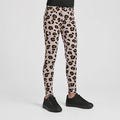 A person shown from the waist down wearing leopard-print leggings with black sneakers, photographed against a clean light gray studio background.