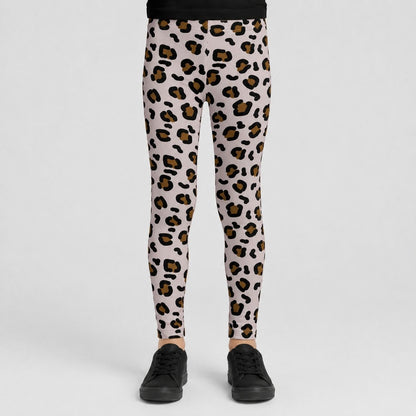 A person wearing leopard-print leggings with black sneakers, shown from the waist down against a light gray studio background.