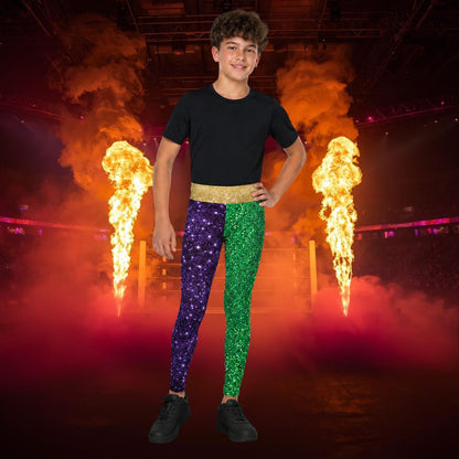 Person wearing colorful retro wrestling tights in green, purple and gold with fire performers in the background
