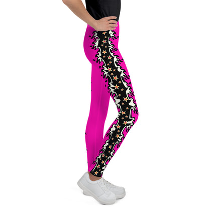 Youth teenager wearing pink cosplay wrestling leggings with a fiery outside edging and love hearts. Facing to the right