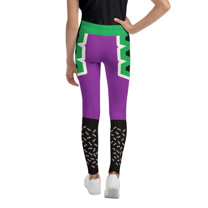 Person wearing purple leggings with green and white geometric design on a white background