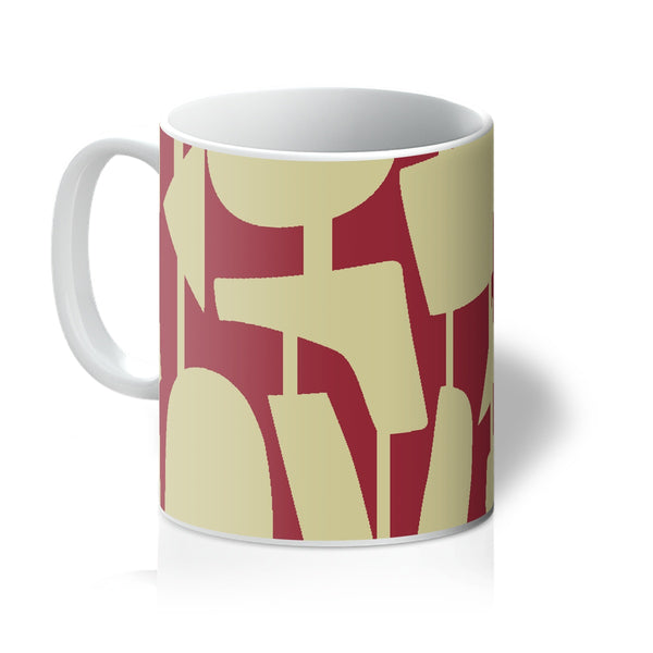 This Mid-Century Modern style ceramic coffee mug mug consists of colorful connected shapes in cream on a vermillion red background