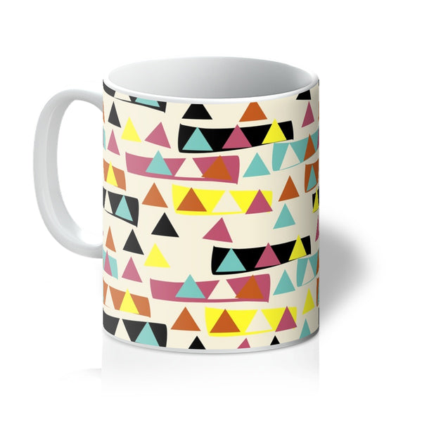 This Mid-Century Modern style mug consists of a colorful, abstract geometric triangle patterned design with blocks of color