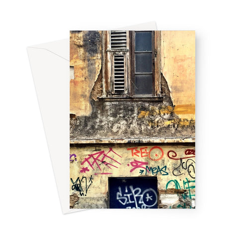Decayed Athenian property frontage with old shutter, broken stucco and graffit on this greeting card