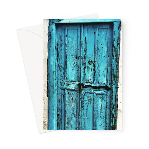 Greeting card showing an old blue door with flaking paint and decrepit woodwork, set in a crumbling doorway.
