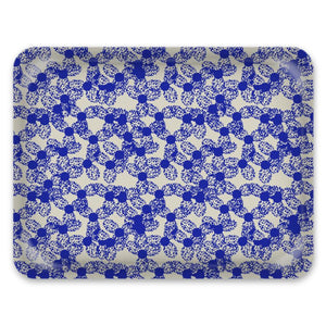 This glossy patterned tray has an abstract blue dotted floral pattern against a pale grey background