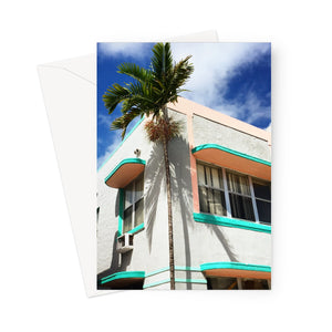 This greeting card shows the corner aspect of a lovely turquoise and pink Art Deco building beside a tall palm.