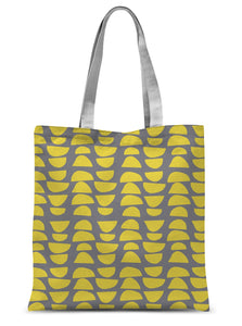 This tote bag has a patterned retro style design of stacked abstract shapes in a vibrant lemon yellow, alternating in reverse against a stunning grey background.
