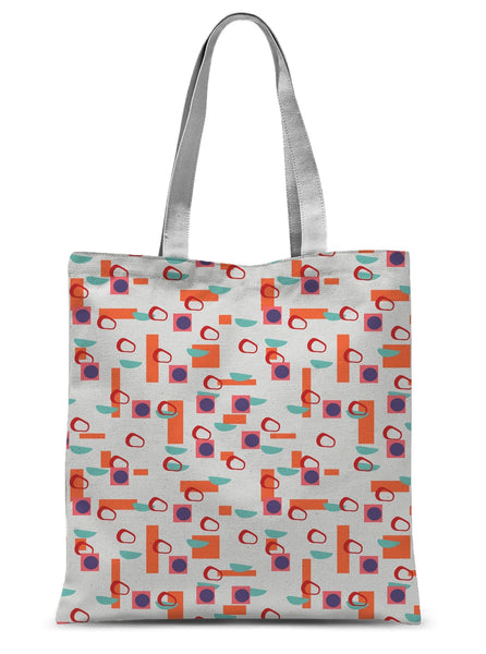 This Mid-Century Modern style tote design consists of colorful geometric blocks in orange, turquoise, red and purple against a soft stone colored background.