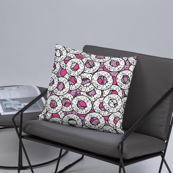 Gorgeous, fun Pink 80s Memphis style sofa cushion or couch pillow from our Splattered Donuts Collection 18x18 featuring a bold pattern of pink and white sprinkled donuts, or maybe they are paint splatters lifestyle image