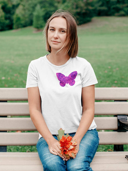 Model wears a single pink floral butterfly cut out on the left hand side of this white cotton t-shirt