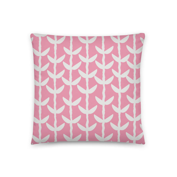 This striking Mid-Century Modern style couch pillow design consists of a series of cream coloured leaves and stems against a soft pink background