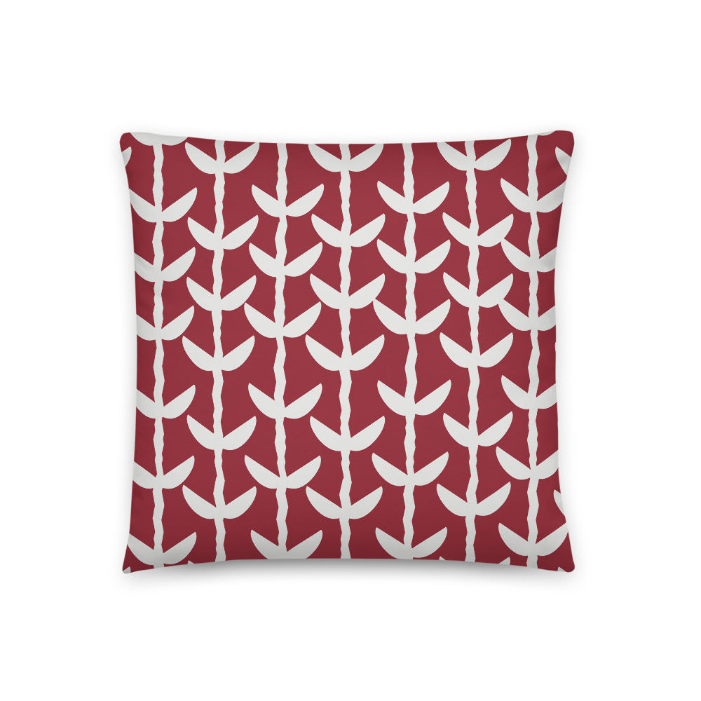 This striking Mid-Century Modern style couch pillow design consists of a series of cream coloured leaves and stems against a crimson red background