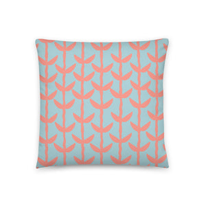 This Mid-Century Modern style couch pillow design consists of a series of salmon pink coloured leaves and stems against a sea foam green background