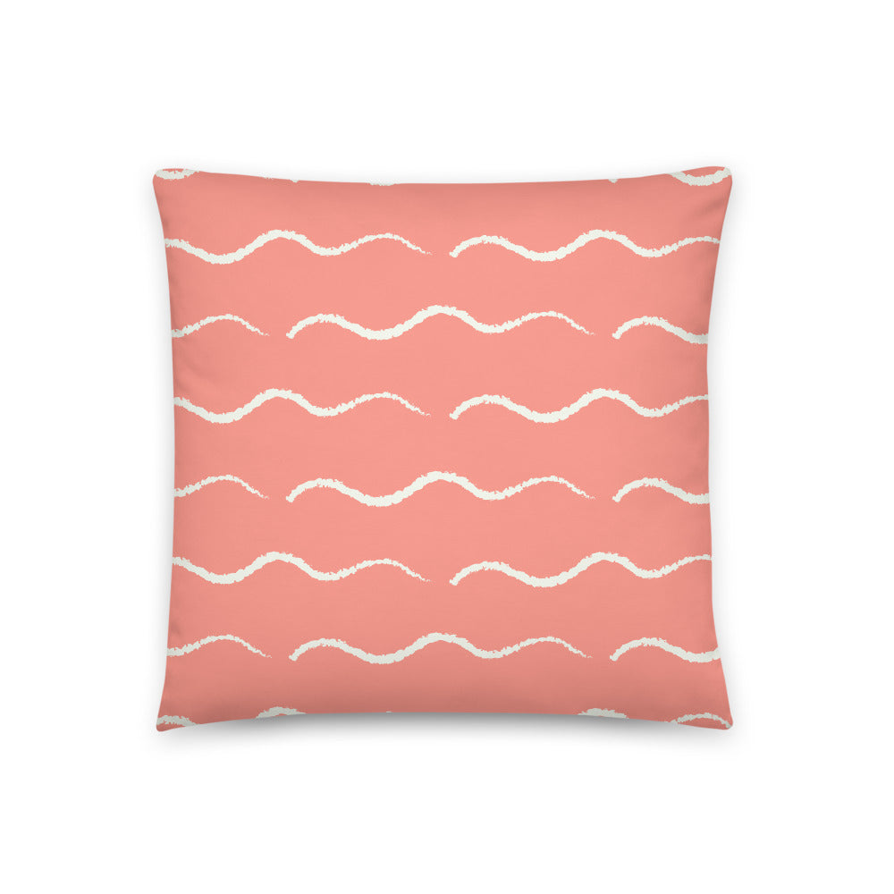 This Mid-Century Modern style couch pillow design consists of a series of horizontal pale cream wave shapes against a salmon pink background