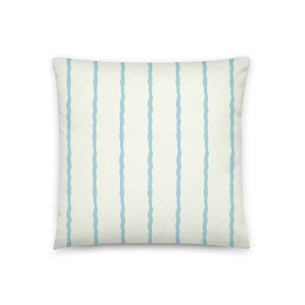 This Mid-Century Modern style scatter cushion consists of jagged vertical seafoam blue stripes against a pale cream background