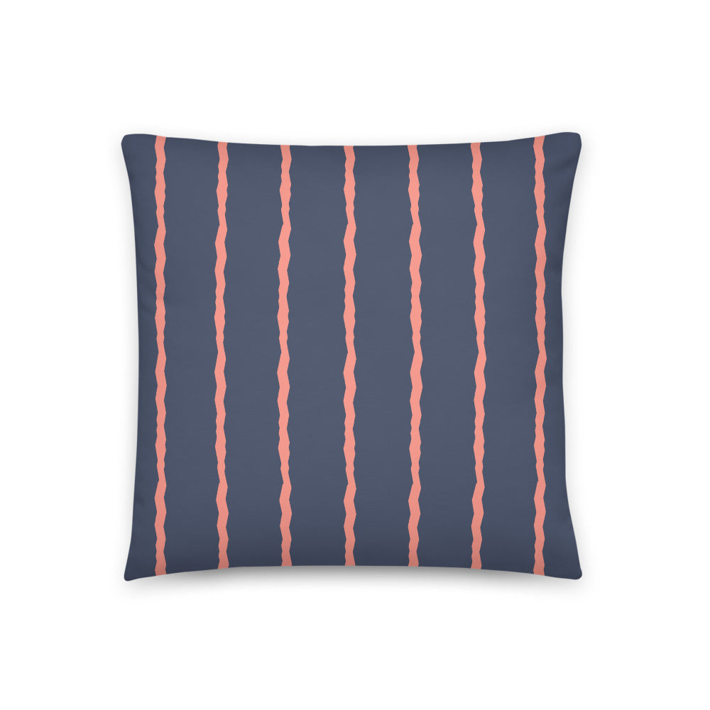 This Mid-Century Modern style scatter cushion consists of jagged vertical salmon pink stripes against a navy blue background