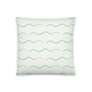 This retro style couch pillow design consists of a series of horizontal sea-foam blue wave shapes against a pale cream background