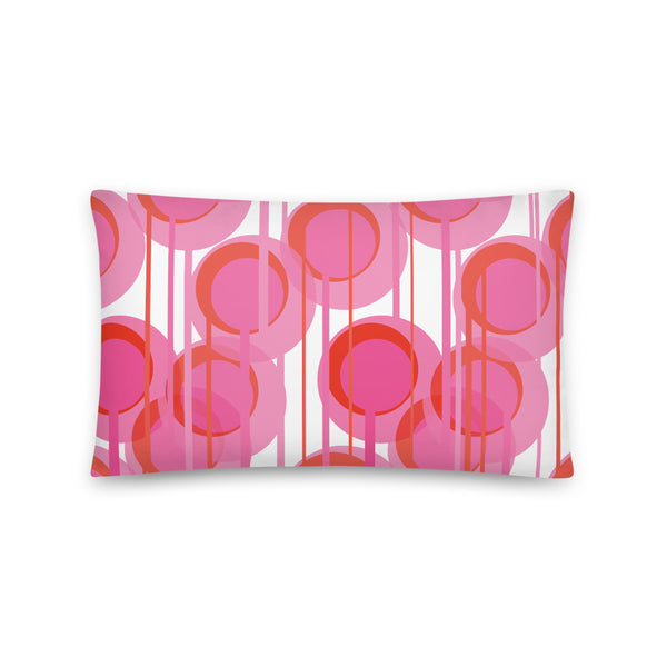 This Mid-Century Modern style sofa pillow consists of colorful geometric circular shapes in various tones of pink, connected vertically by narrow tentacles to form and almost hanging mobile type abstract circular pattern on a white background