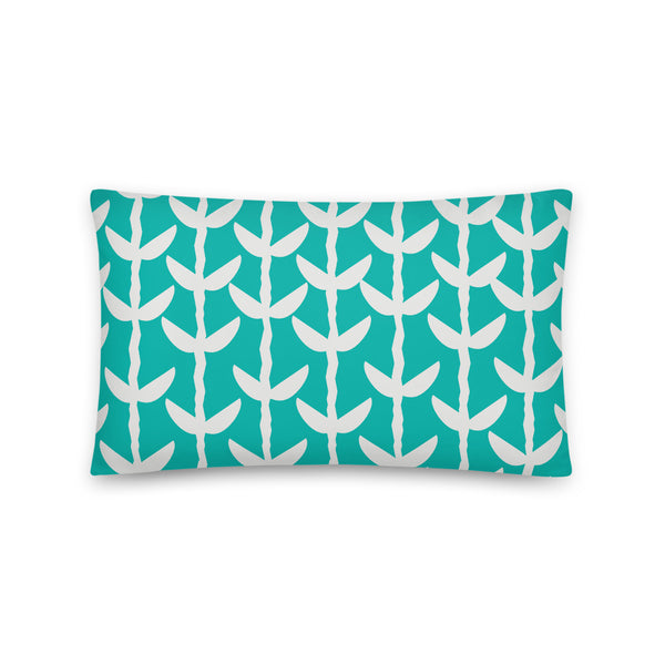 This striking Mid-Century Modern style couch pillow design consists of a series of cream coloured leaves and stems against a turquoise blue background