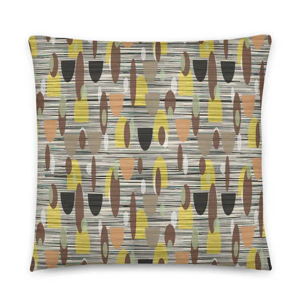 This Mid-Century Modern style couch pillow design consists of a series of earthy muted oval shapes in browns, yellow, black and peach against a patterned background of black and grey crisscross and cream colours