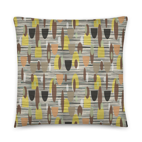 This Mid-Century Modern style couch pillow design consists of a series of earthy muted oval shapes in browns, yellow, black and peach against a patterned background of black and grey crisscross and cream colours