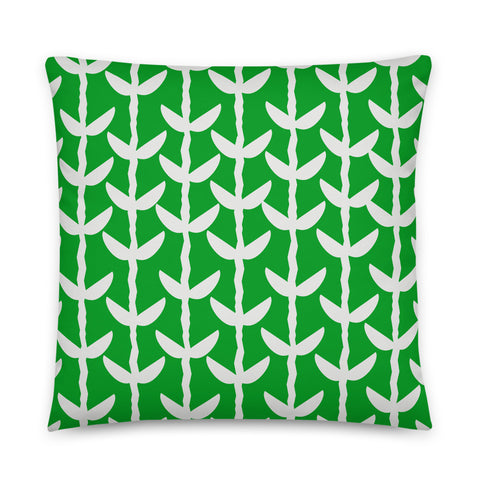 This Mid-Century Modern style couch pillow design consists of a series of cream coloured leaves and stems against an emerald green background