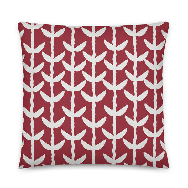 This striking Mid-Century Modern style couch pillow design consists of a series of cream coloured leaves and stems against a crimson red background