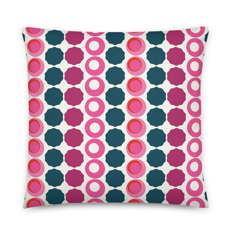 This Mid-Century Modern style sofa pillow consists of colorful circular and concentric shapes in various tones of pink and top against a light cream background