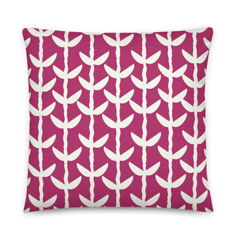 This striking Mid-Century Modern style couch pillow design consists of a series of cream coloured leaves and stems against a purple magenta background