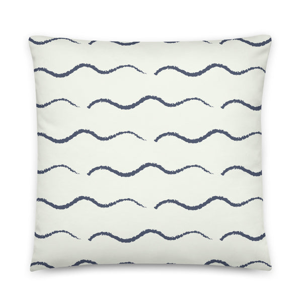 This Mid-Century Modern style couch pillow design consists of a series of horizontal navy blue wave shapes against a pale cream background