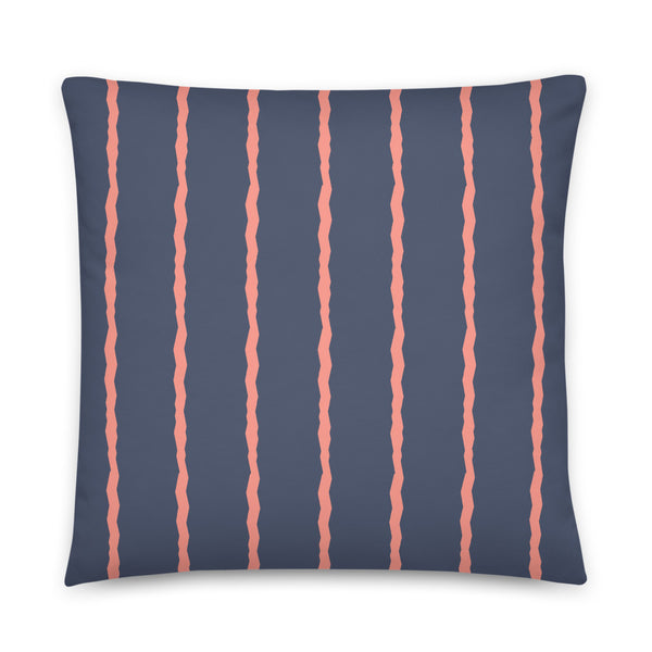 This Mid-Century Modern style scatter cushion consists of jagged vertical salmon pink stripes against a navy blue background