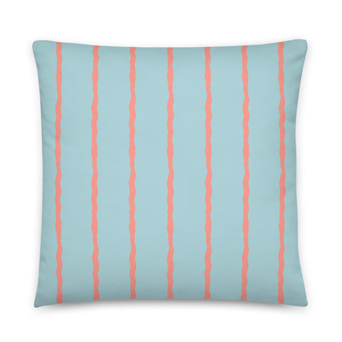 This Mid-Century Modern style scatter cushion consists of jagged vertical salmon pink stripes against a sea-foam blue background