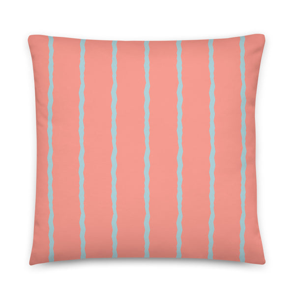 This retro style scatter cushion consists of jagged vertical seafoam blue stripes against a salmon pink background